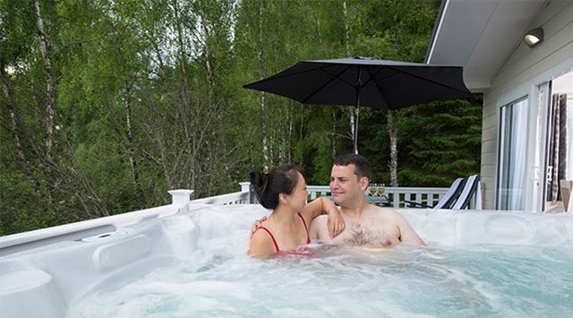 A couple relaxing in their hot tub