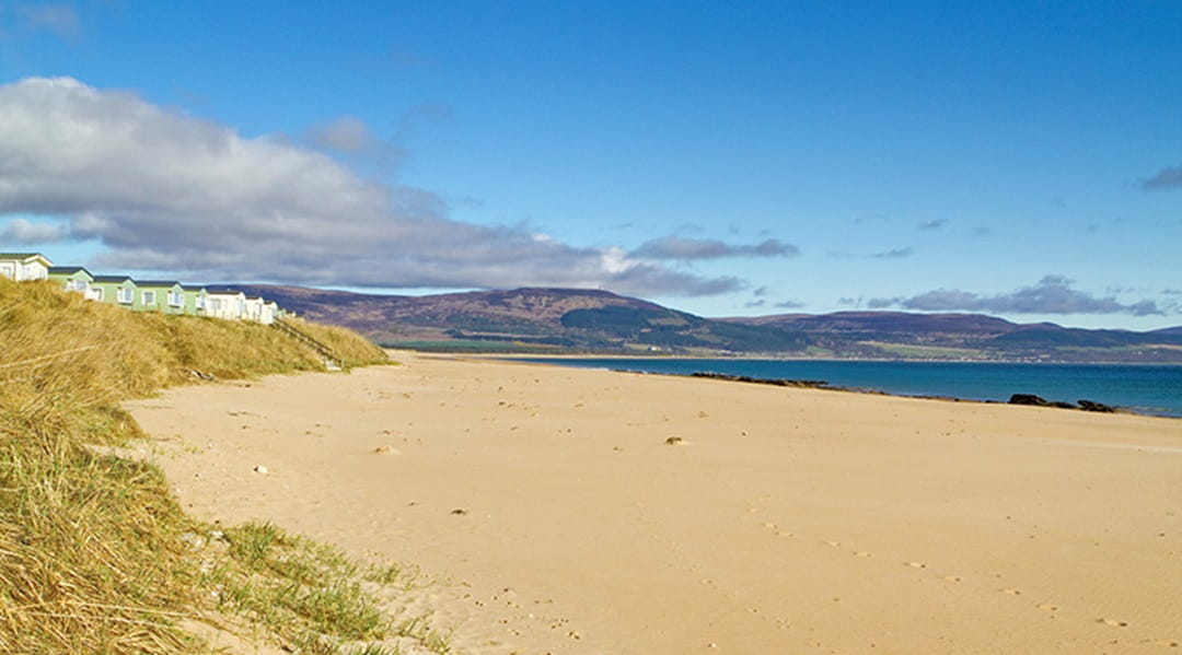 A row of static caravans at Grannie's Heilan' Hame Holiday Park overlooking beautiful Embo Beach in Scotland