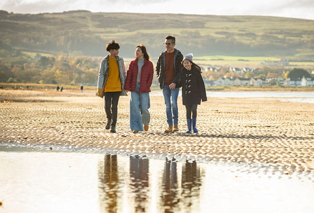 A family going for an autumn beach walk in Scotland