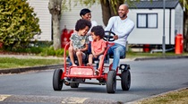 Families riding karts around Trecco Bay on a sunny day