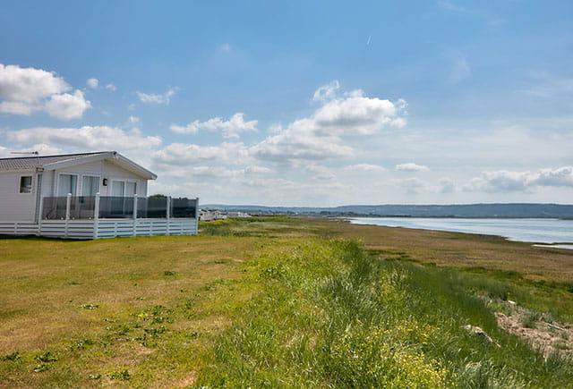 A caravan overlooking the sea on a sunny day in Wales