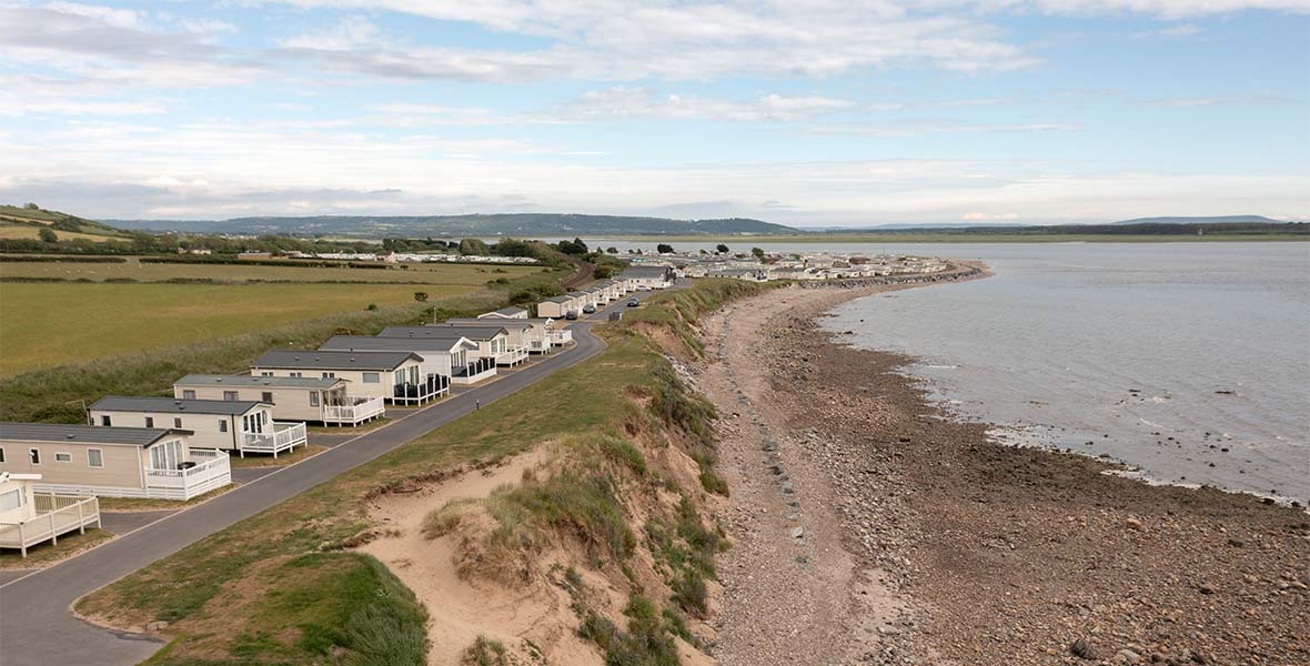 A row of caravans overlooking the sea on the Welsh Coast