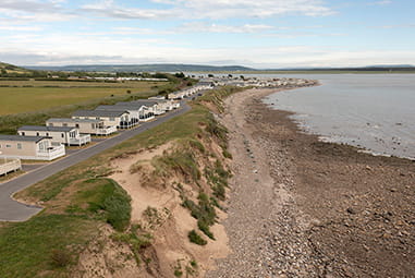 A row of caravans overlooking the sea on the Welsh Coast