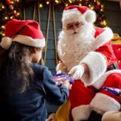 Santa giving gift to child