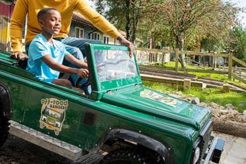 Boy riding off road rangers car