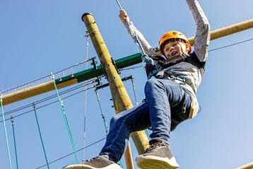Boy on high ropes in the sunshine