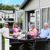 Family sat on veranda at Parkdean Resorts