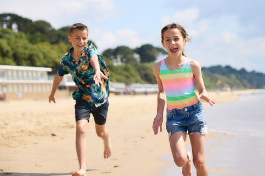 Boy and girl running on the beach