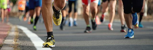 the feet of many runners running along a road on the Great North Run