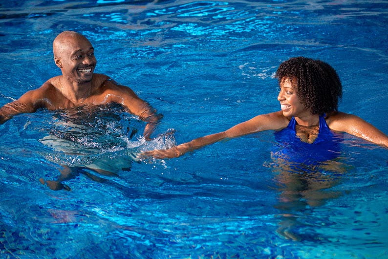lifeguard accompanying a child in the swimming pool
