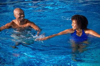 lifeguard accompanying a child in the swimming pool