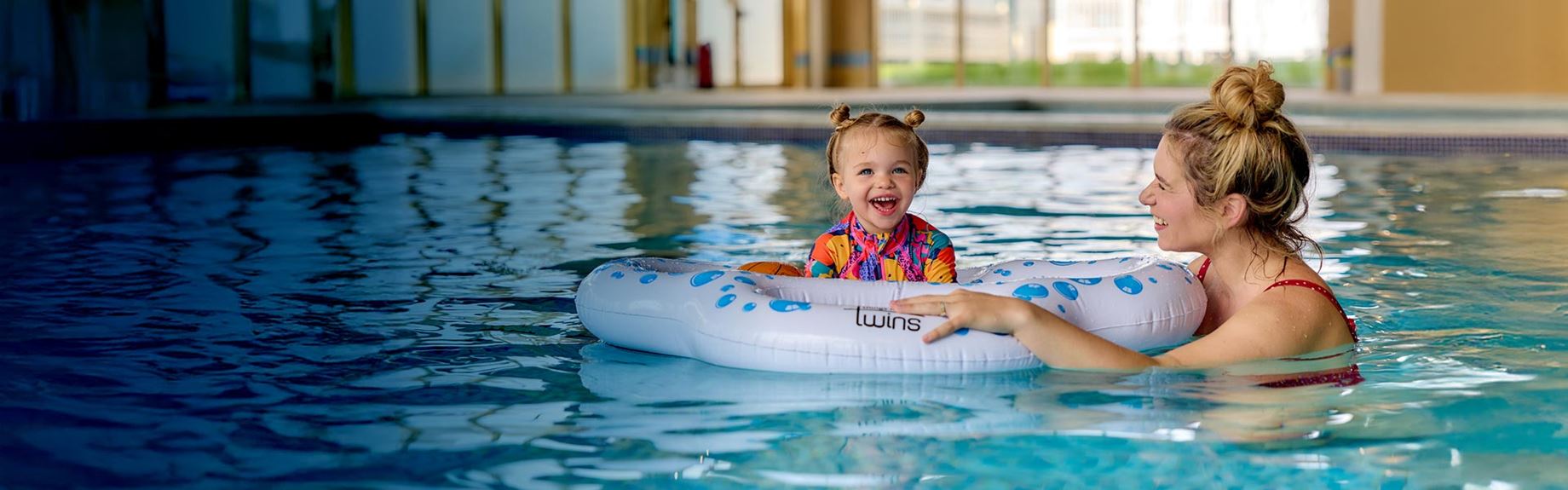 father with kids in swimming pool