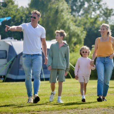 Family walking hand in hand through Parkdean Resorts