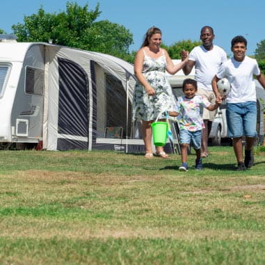 Family walking through Parkdean Resorts
