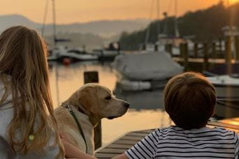 Family with dog looking out at the sea
