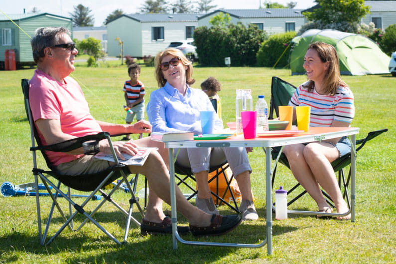 Friends sat on camp chairs at Parkdean Resorts