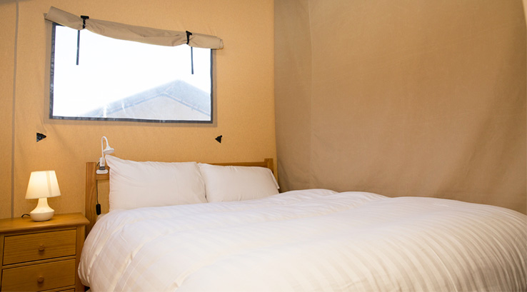 Glamping tent bedroom with double bed