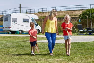 Mum and children walking through field