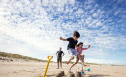 Kids jumping on beach