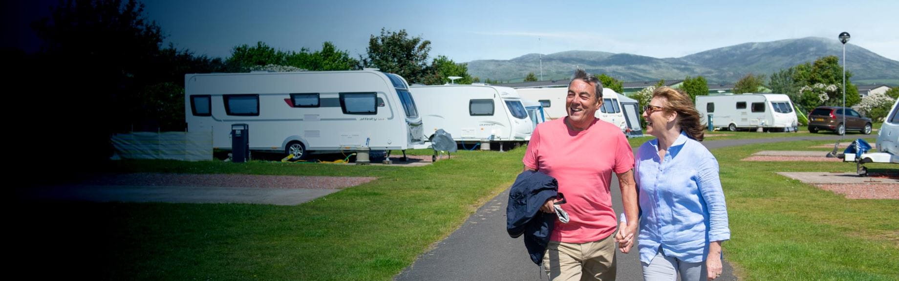 Couple next to caravans