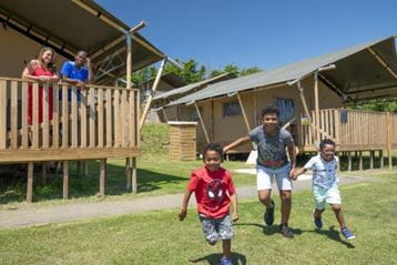 Family outside glamping