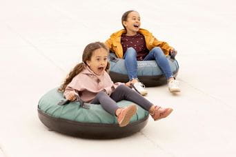 two young kids in ring tubes