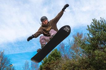 a snowboarder in a mid air jump