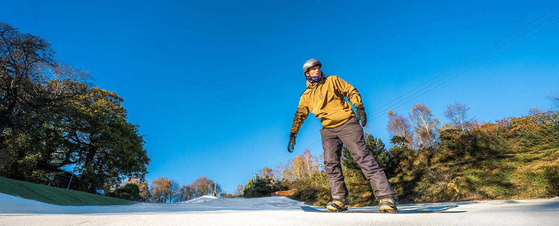 a snowboarder going down the ski slope