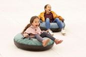 two young kids in ring tubes