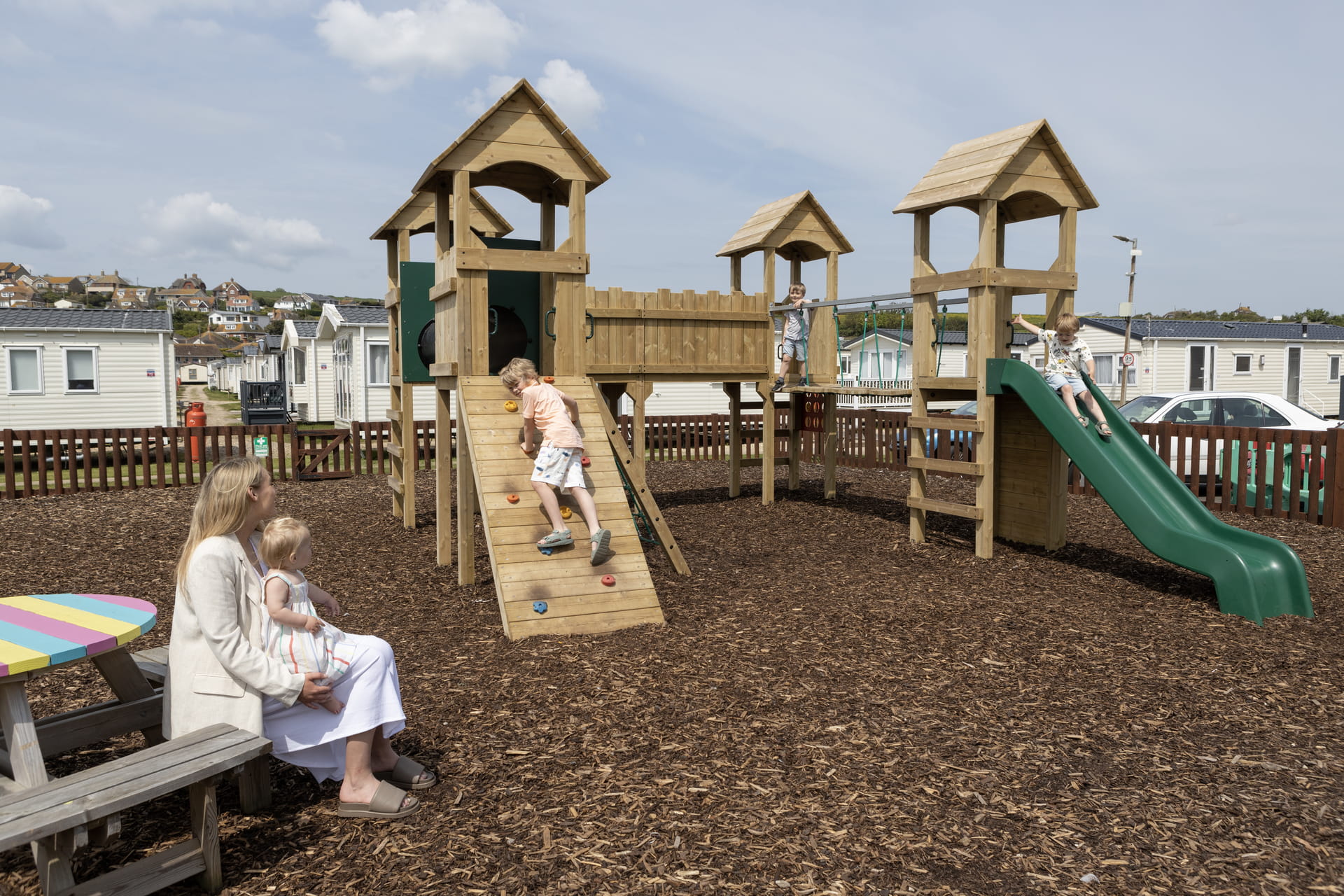 Kids and a parent on a playground