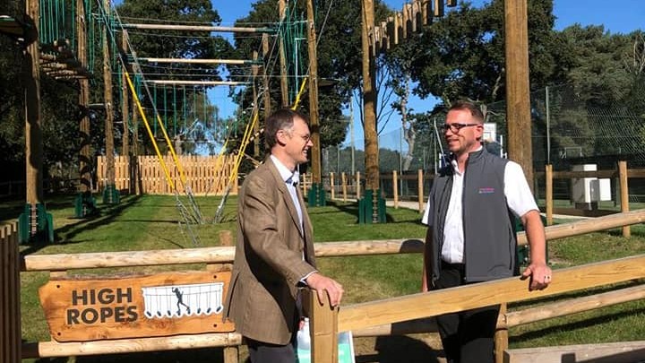 Michael Tomlinson MP and Sandford General Manager stand in front of the high ropes course