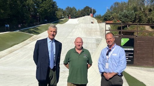 Richard Drax MP and two members of the Warmwell park team stand in front of the ski slope
