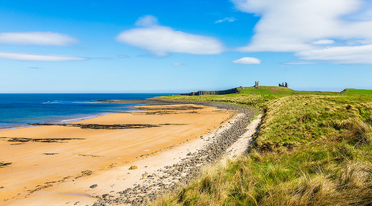 Embleton Bay in Northumberland with Dunstanburgh Castle in the distance