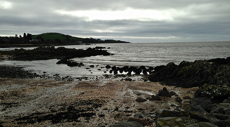 Cloudy skies over Rockcliffe Beach in Scotland
