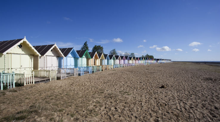 Colourful beach huts overlooking West Mersea Beach in Essex