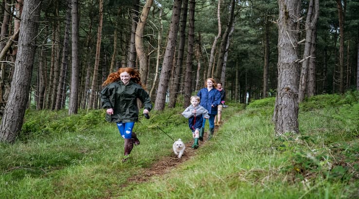 Children running in a forest