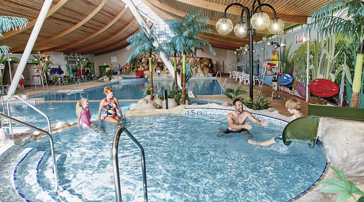 People enjoying the indoor swimming pool at Vauxhall Holiday Park