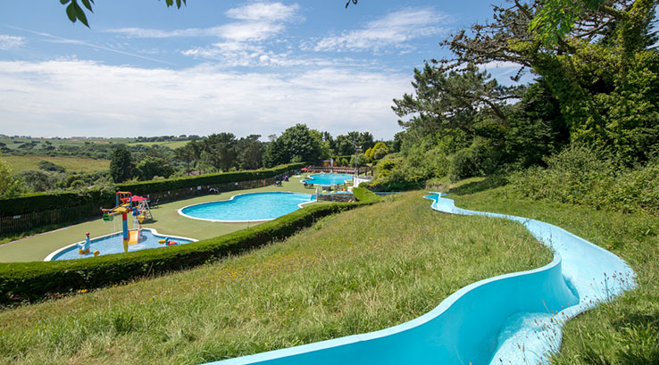 A view of the outdoor swimming pools from the top of the waterslide at Newquay Holiday Park