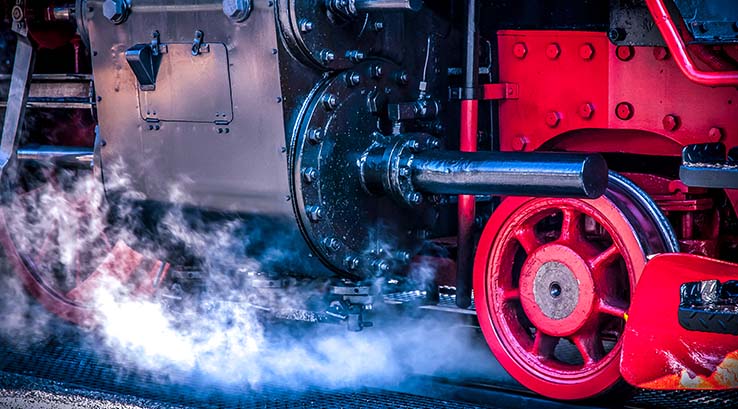 The engine and wheels of a steam train close up