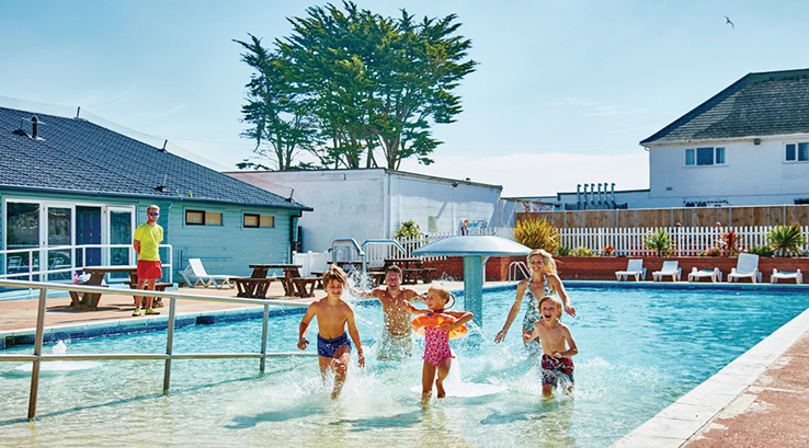 A family stepping out of the outdoor swimming pool at Kessingland Beach Holiday Park