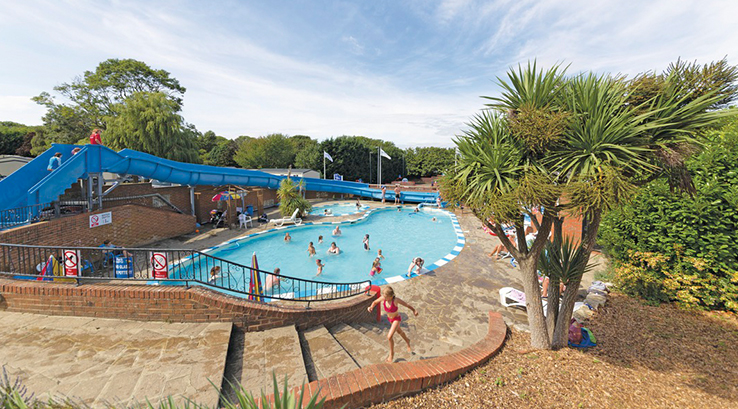 The outdoor swimming pool and flume at Lower Hyde Holiday Park