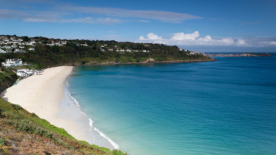 Pristine Carbis Bay Beach, with the town of St Ives visible in the next bay along