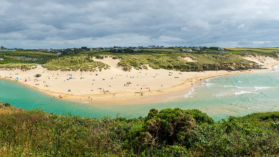 The blue waters of the River Gannel, flowing out to sea in front of Crantock Beach