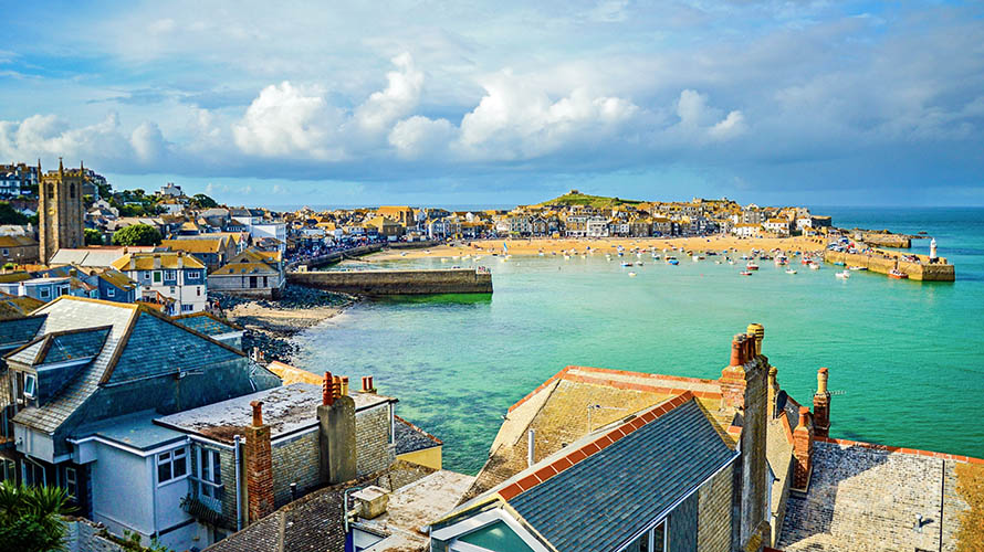 Colourful houses poised around the turquoise waters of St Ives Harbour