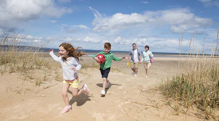 children playing on beach Nairn Scotland