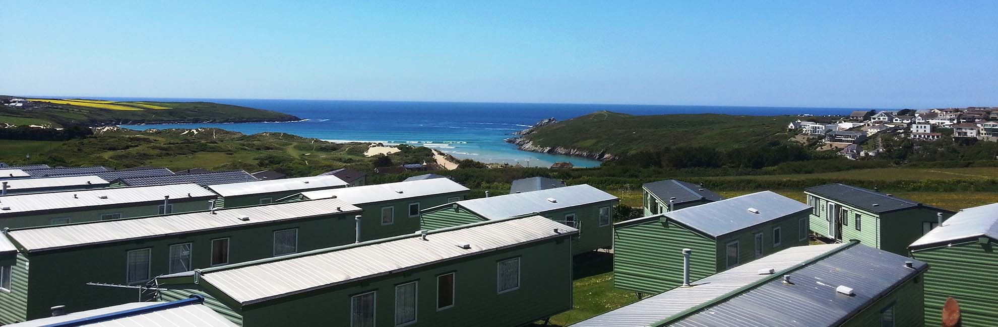 A view across the caravans overlooking the sea at Crantock Beach Holiday Park