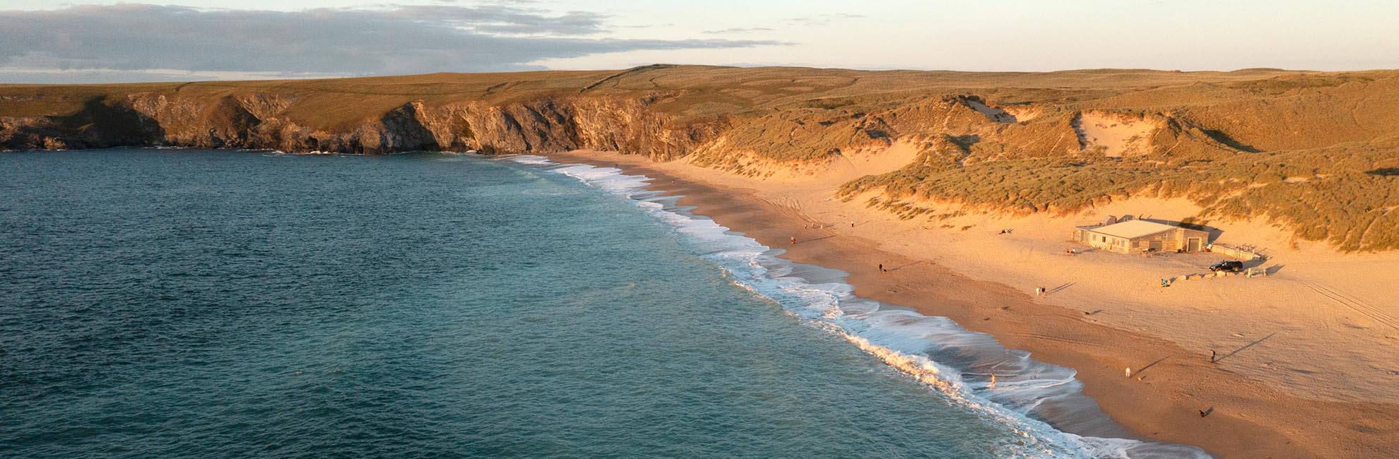 An aerial view over Holywell Bay Beach