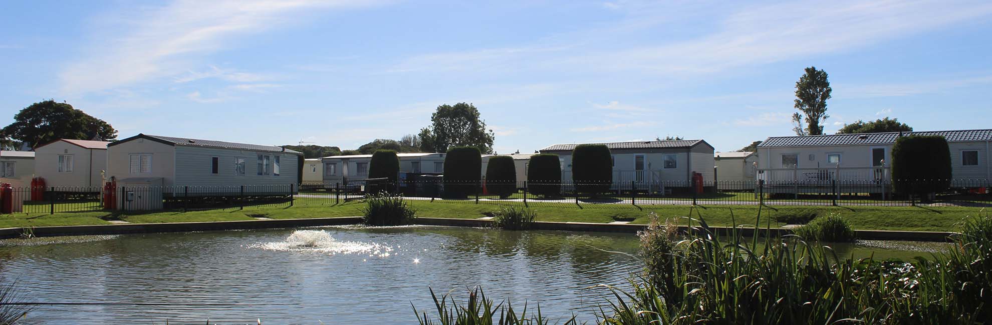A view of the caravans overlooking the lake at Sunnydale Holiday Park
