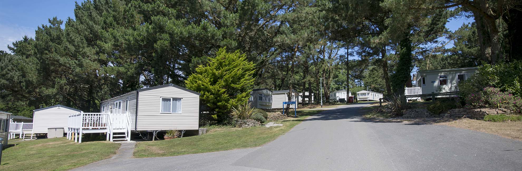 Caravans on a leafy hillside at Newquay Holiday Park in Cornwall