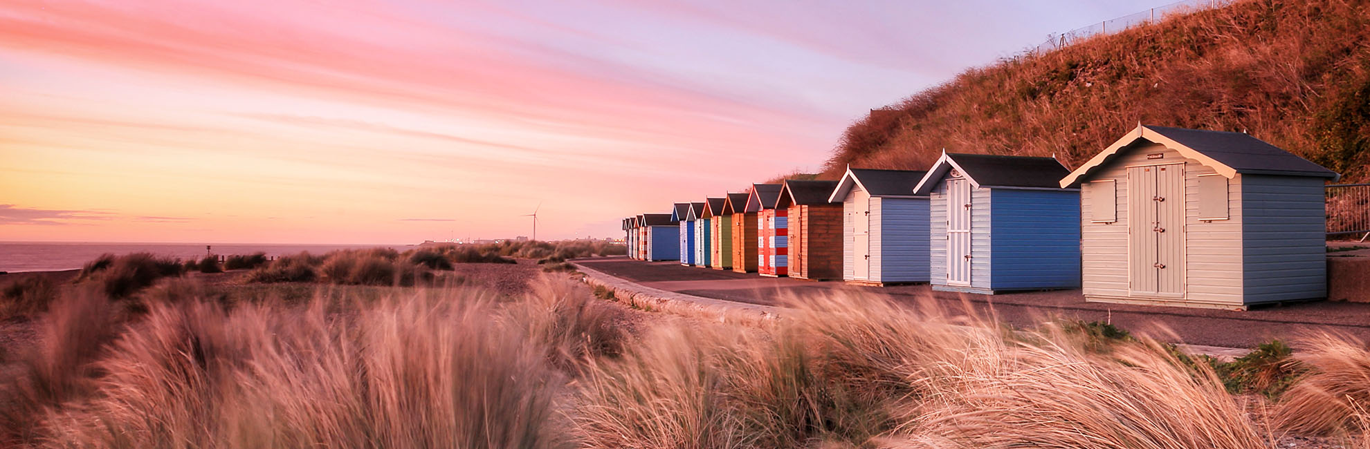 Beach huts at sunset on a beach in Suffolk